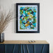 Framed abstract art piece on a wall above a blue cabinet.