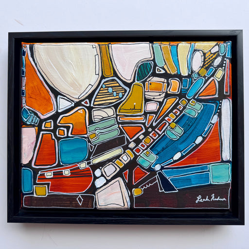 Framed abstract artwork with colorful geometric shapes on a white background