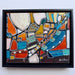 Framed abstract artwork with colorful geometric shapes on a white background